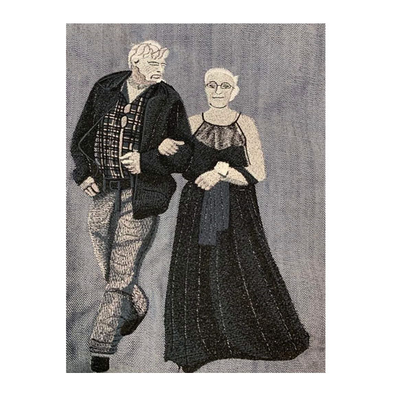 High-quality digitization of an old couple photo. The husband and wife are both smiling and looking at each other. The photo is taken in a black and white filter and has a grainy texture.